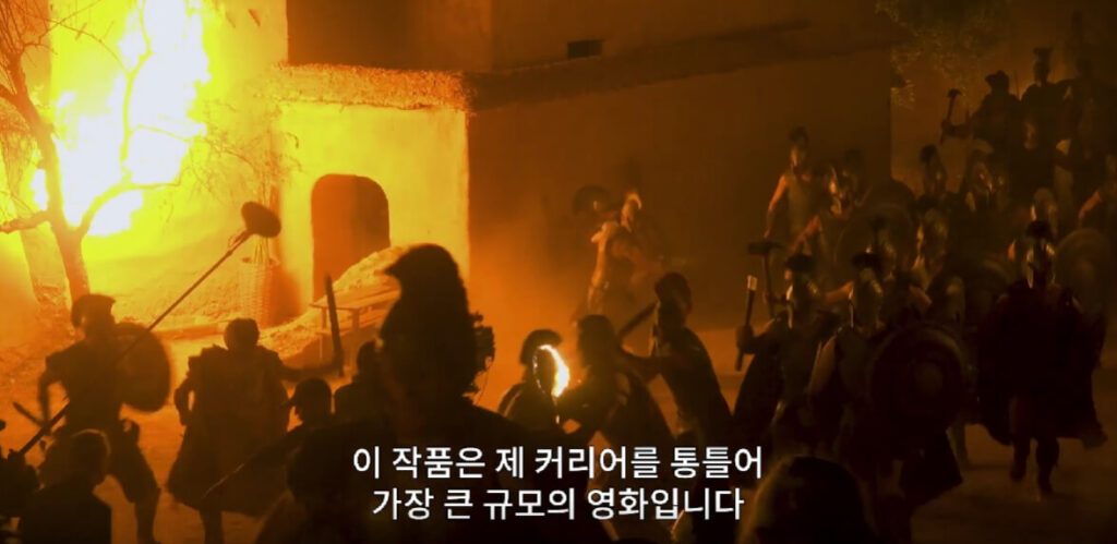 영화 오디세이 대규모 전투 장면과 감독의 커리어 최대 규모임을 설명하는 자막